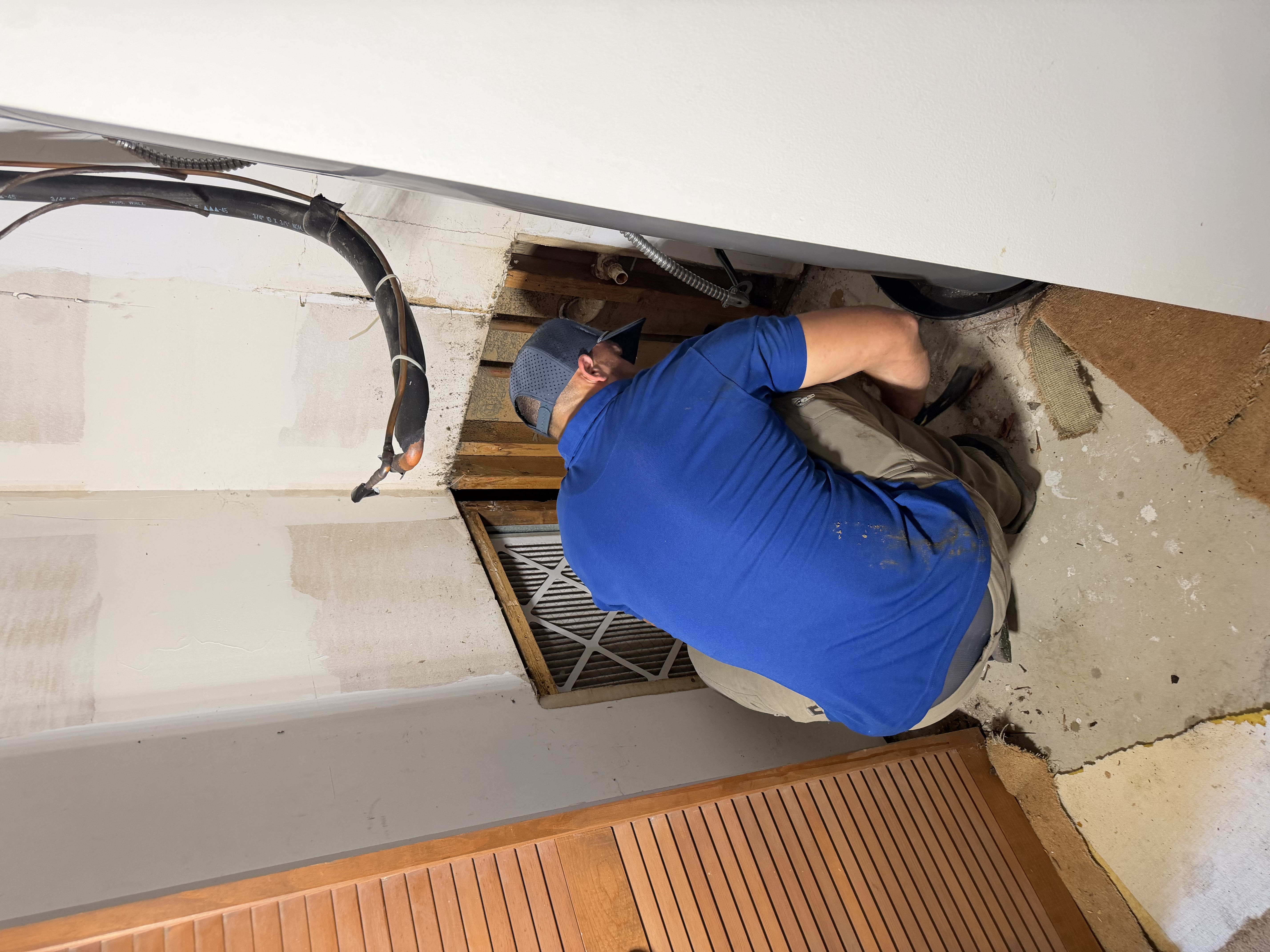 Casey working on an indoor HVAC access area